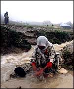 Woman washing clothes in a river