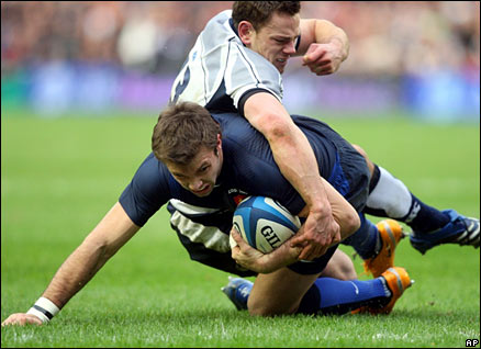 France's Vincent Clerc, crosses the line to score past Scotland's Nick De Luca during their Six Nations match at Murrayfield