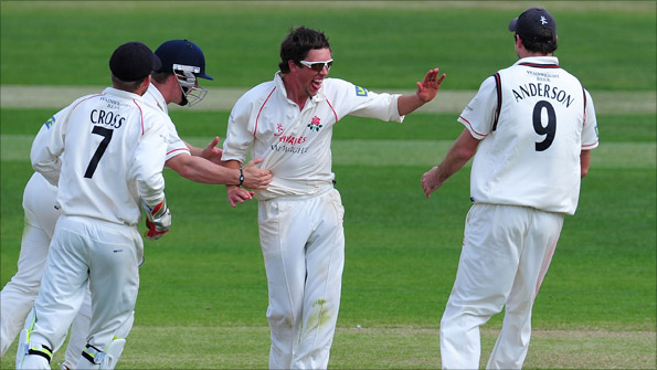 Lancashire spinner Simon Kerrigan celebrates a wicket with his team-mates