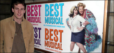 Dominic Shaw by the poster for Hairspray