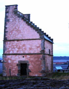 16th-century Scottish building with pink walls and sharply sloping roof