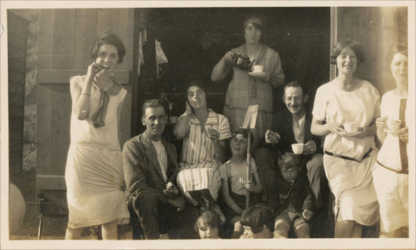 A family have tea in a beach hut