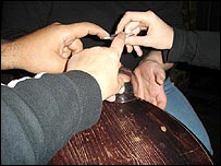 The glass nearly falls during a séance