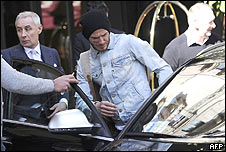 Beckham is helped into a car
