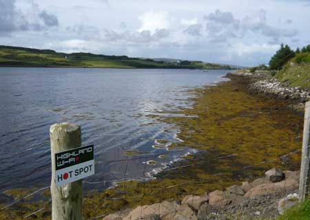 A lake on the Isle of Skye with a sign advertising Wi-Fi internet