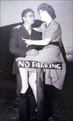 Couple sat on No Parking Sign