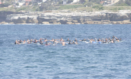 And the Bombie Crew - Shane Oliver centre - form the Surfers Circle of Life, and commit Robs ashes to his beloved ocean.