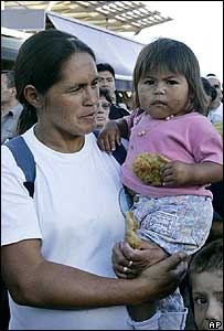 Criança come alimentos servidos aos pobres em Puerto Madero