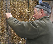 Man making straw bale wall