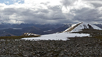 View from the top of Stob a'Choire Mheadhoin showing the surrounding mountains, some with snow on top.