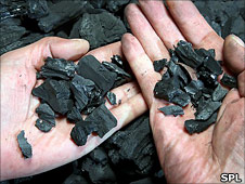 Hands holding biochar