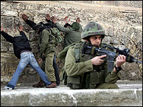 سرباز اسراییلی در حال بازرسی فلسطینیان در الخلیل