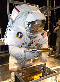 جيمز رايلی در لباس فضانوردی يکی از تکنيک های تعمير را می آزمايد