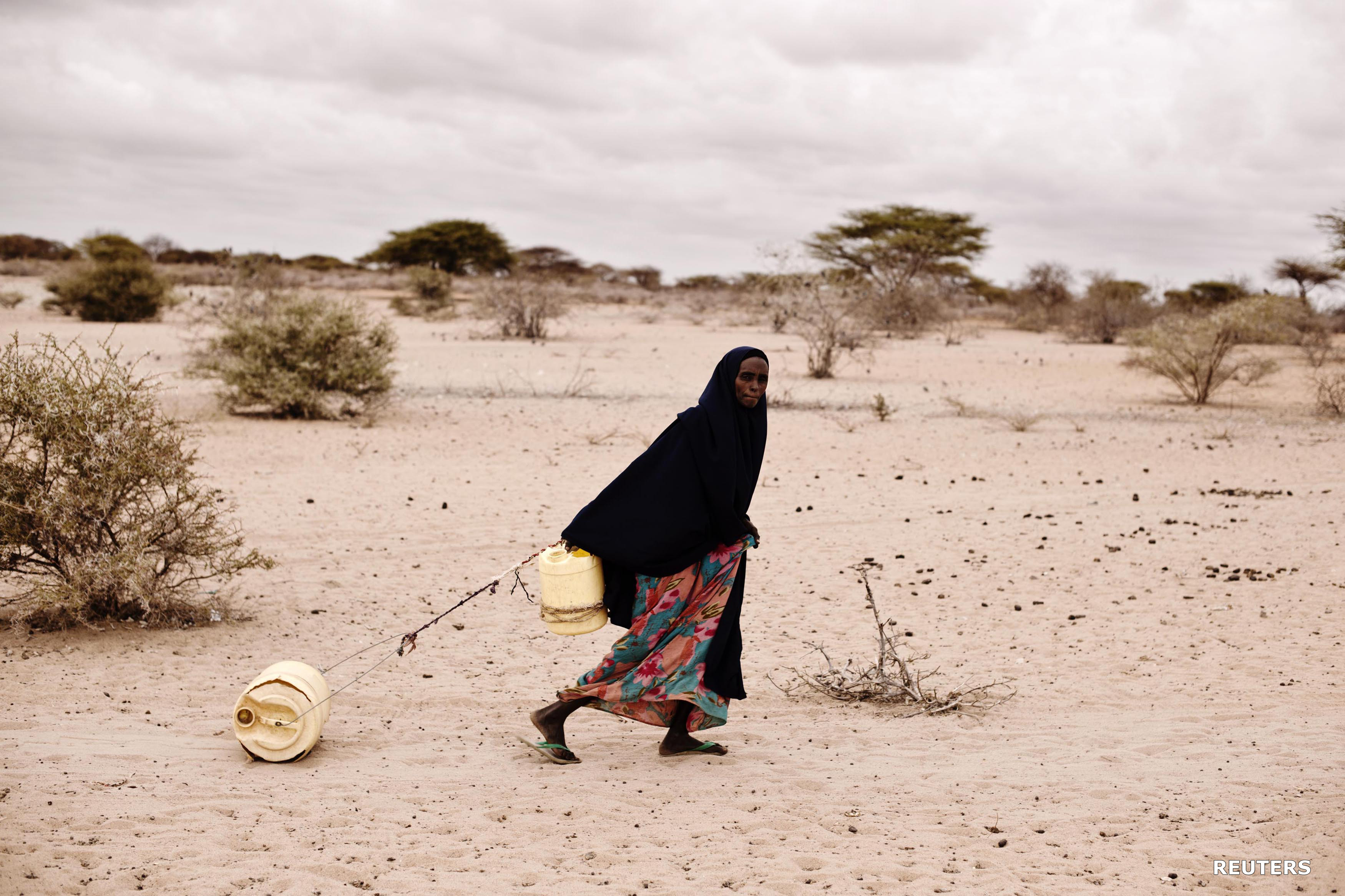 Somali woman dragging a jerry can