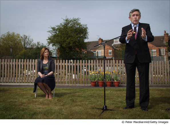 Gordon Brown is watched by his wife Sarah Brown as he speaks to supporters in the garden of Arnold Mill Primary School