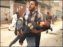 Palestino carrega criança ferida no ataque em Rafah