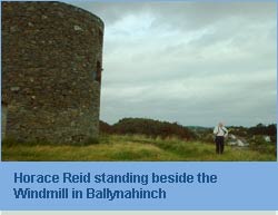 Photo of Horace Reid beside Ballynahinch windmill