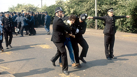 Two policemen arresting a miner at Orgreave