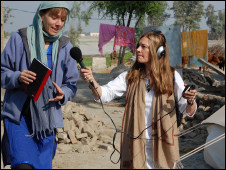 Jill McGivering (left) and producer Caroline Finnigan recording for Assignment in a flood-affected village in Pakistan