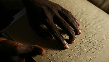 A blind person reading braille