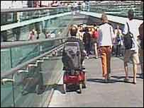 Peter crossing a bridge in his wheelchair