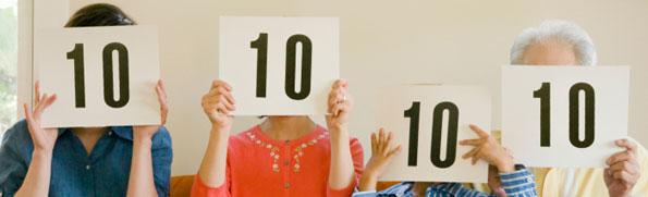 Family holding up scorecards with 10s