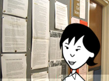 Helen looking at a noticeboard