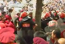 Malaysian police tackling a street protest