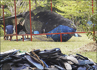 A whale sculpture created from flip flops