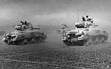 British Sherman tanks advance in North Africa during World War Two