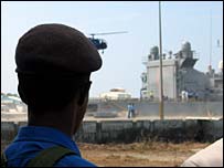 Sri Lankan Naval soldier watches as Indian helicopter takes off from an Indian ship (photo Dushiyanthini Kanagasabapathipillai)