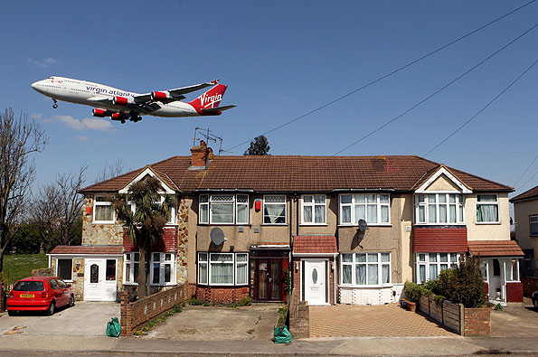 Plane flying over house