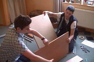 Ella and Kit try to assemble a desk