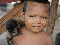A monkey on a child's shoulder