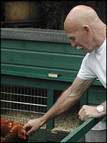 Alan feeding chickens 
