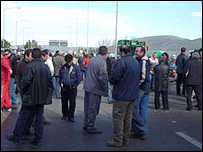Greek farmers standing on blocked road