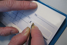 Someone writing a cheque