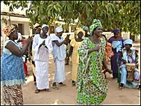A colourful dancing group improvises songs
